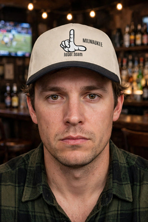 Person wearing the Milwaukee loser hat, deadpan