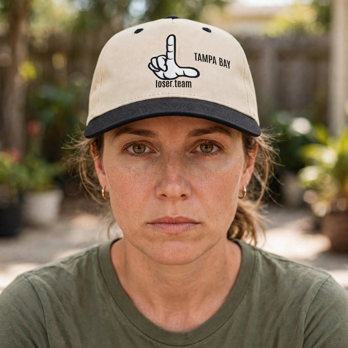 Person wearing the Tampa Bay loser hat, deadpan